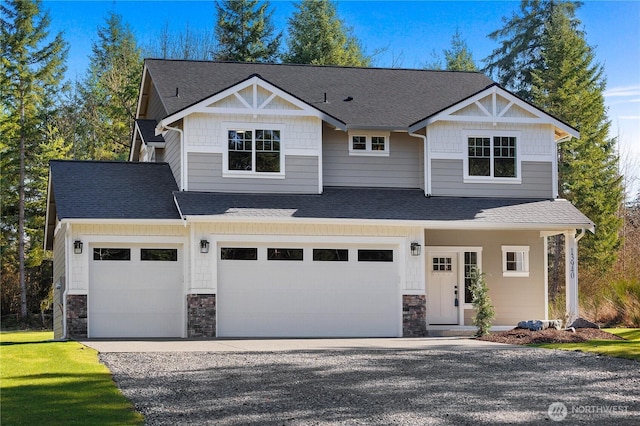 craftsman-style home with a garage, stone siding, roof with shingles, and driveway