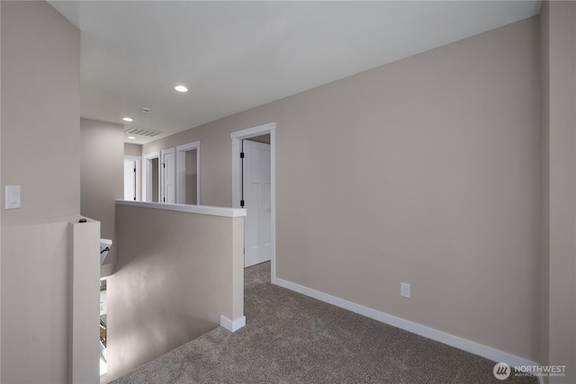 hallway with carpet, recessed lighting, visible vents, an upstairs landing, and baseboards