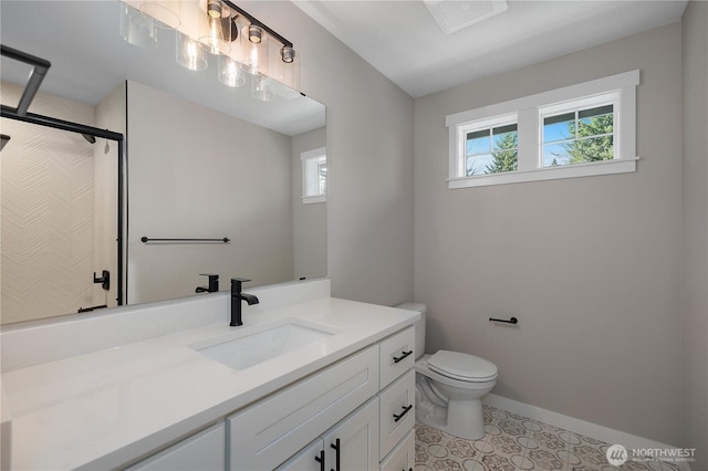 bathroom featuring baseboards, walk in shower, a wealth of natural light, and vanity