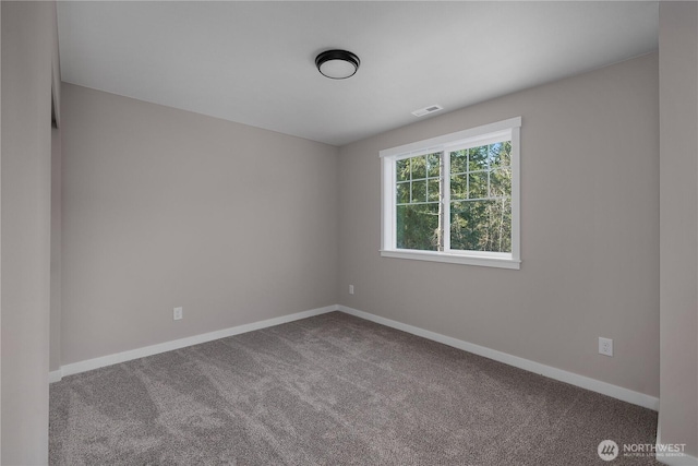 carpeted empty room with visible vents and baseboards