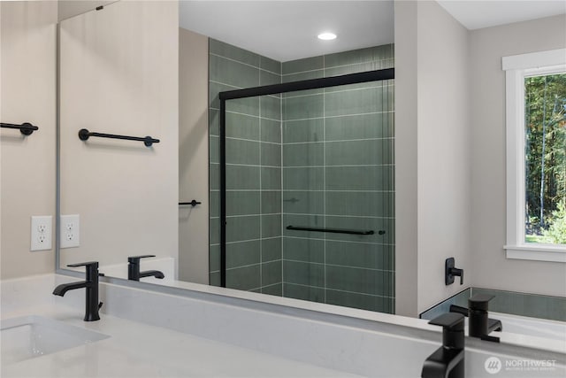 full bath with plenty of natural light, a sink, and a shower stall