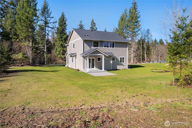 rear view of property with a yard