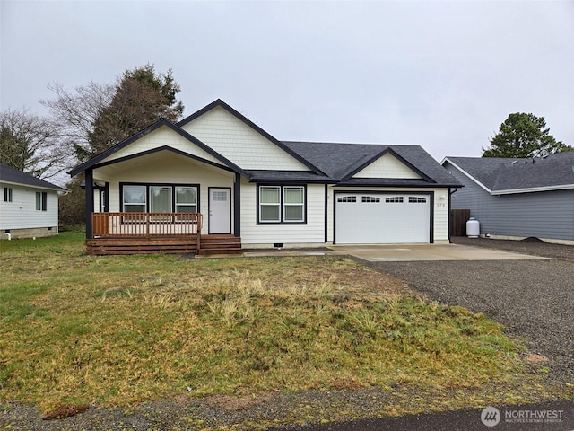 view of front of property featuring a front lawn, a garage, and driveway