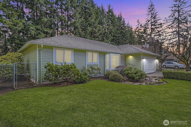 ranch-style home with a front yard, roof with shingles, a garage, and fence