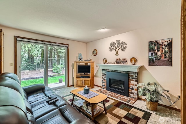 living area featuring a brick fireplace and baseboards