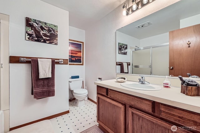 full bathroom featuring vanity, toilet, baseboards, and a stall shower