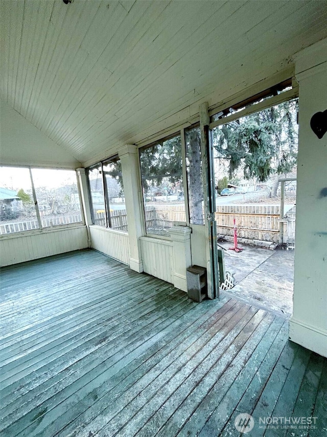 unfurnished sunroom with wooden ceiling and vaulted ceiling