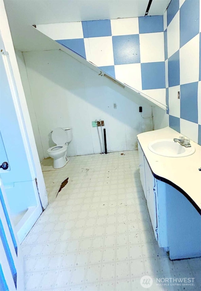 bathroom featuring tile patterned floors, toilet, and vanity