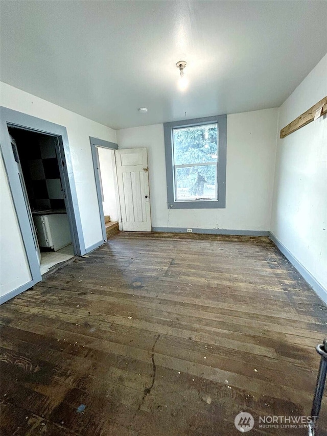 unfurnished bedroom featuring baseboards and wood finished floors