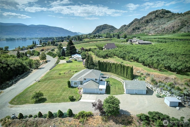 birds eye view of property featuring a water and mountain view and a rural view