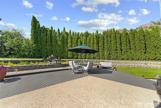 exterior space featuring a forest view and outdoor dining area