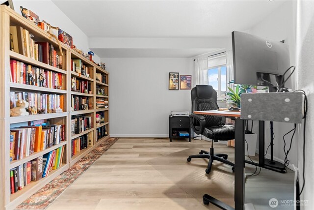 office featuring baseboards and wood finished floors