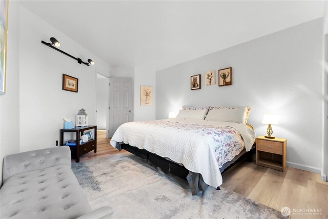 bedroom featuring wood finished floors and baseboards