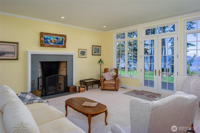 373 Eliza Rd, Lopez Island, WA 98261 - living room with french doors, crown molding, carpet floors, a tile fireplace, and recessed lighting