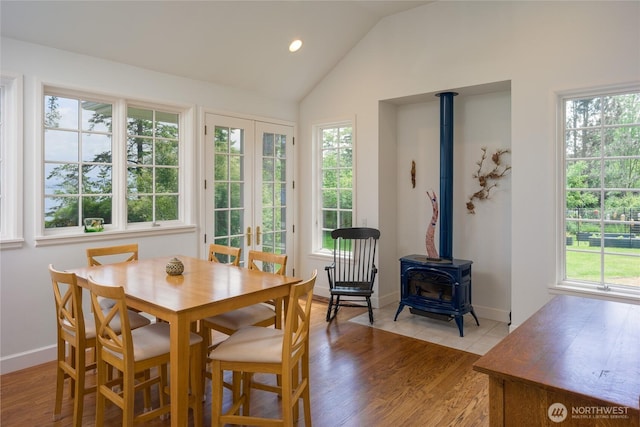 373 Eliza Rd, Lopez Island, WA 98261 - dining space featuring a wood stove, french doors, vaulted ceiling, light wood-type flooring, and recessed lighting