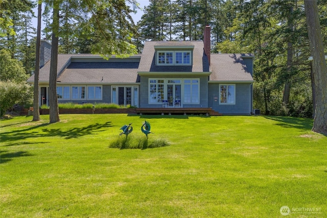 373 Eliza Rd, Lopez Island, WA 98261 - view of front of house with a chimney, a front yard, a deck, and roof with shingles