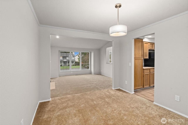 unfurnished room featuring crown molding, baseboards, and light carpet