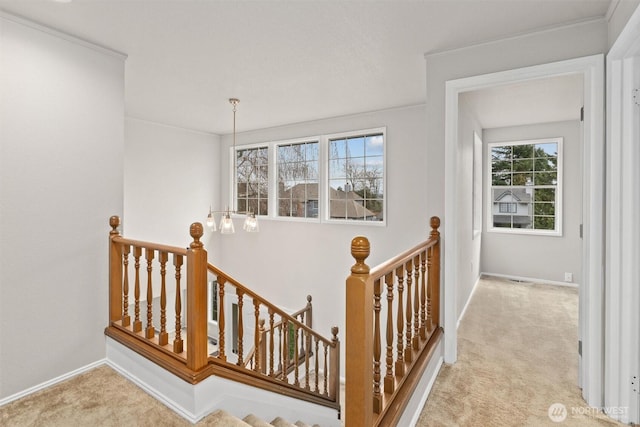 staircase with baseboards and carpet floors