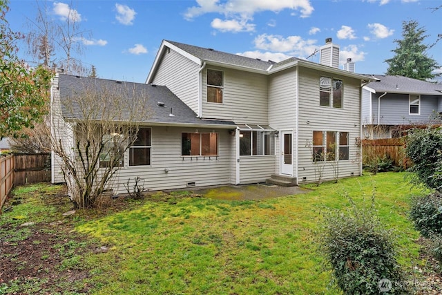 back of property with a yard, a fenced backyard, a shingled roof, a chimney, and crawl space