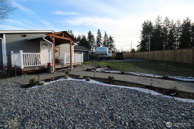 exterior space with a deck, a patio, and fence