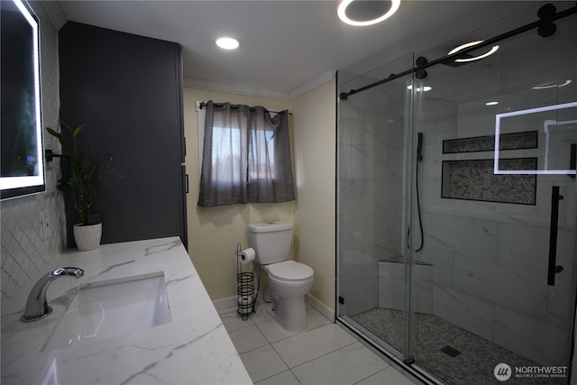 full bath featuring toilet, a stall shower, baseboards, and vanity