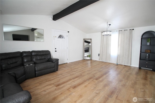 living room with lofted ceiling with beams, baseboards, and wood finished floors