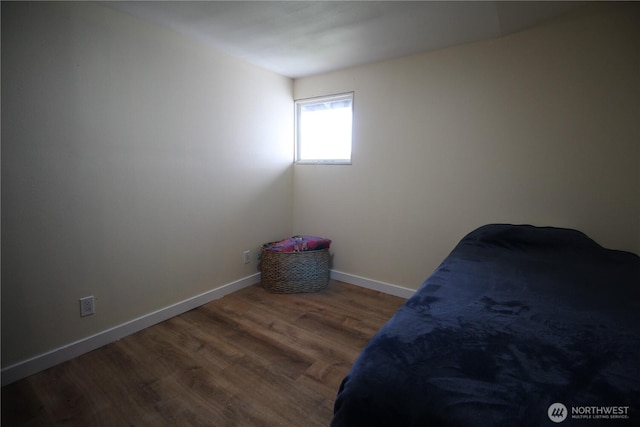 unfurnished bedroom with baseboards and wood finished floors