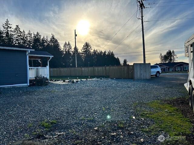 yard at dusk featuring fence