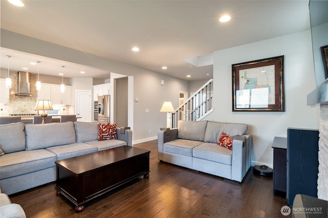 living area featuring recessed lighting, baseboards, dark wood finished floors, and stairs