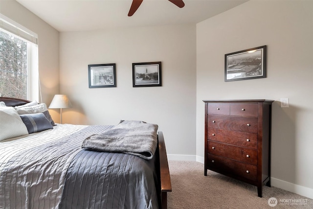 carpeted bedroom featuring baseboards and ceiling fan