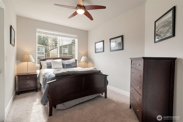 bedroom with baseboards, light colored carpet, and a ceiling fan