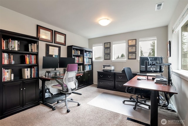 home office featuring visible vents and light carpet