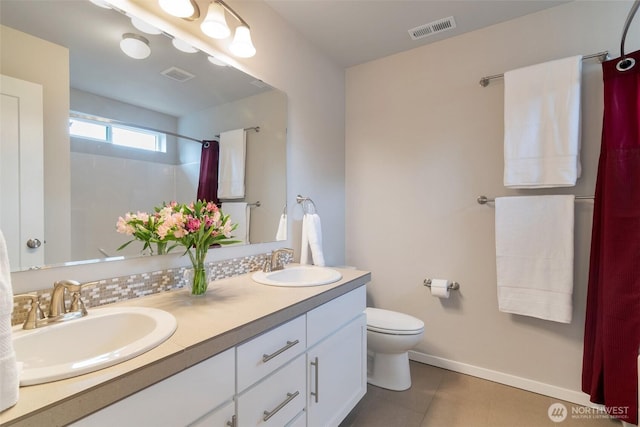 bathroom featuring a sink, visible vents, and toilet