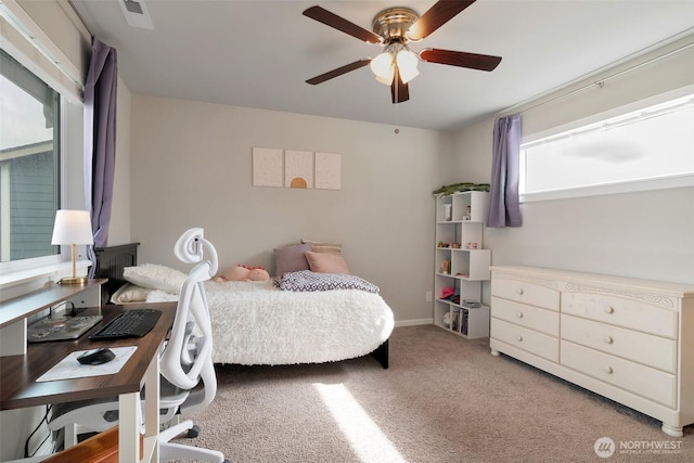 carpeted bedroom featuring visible vents, baseboards, and a ceiling fan