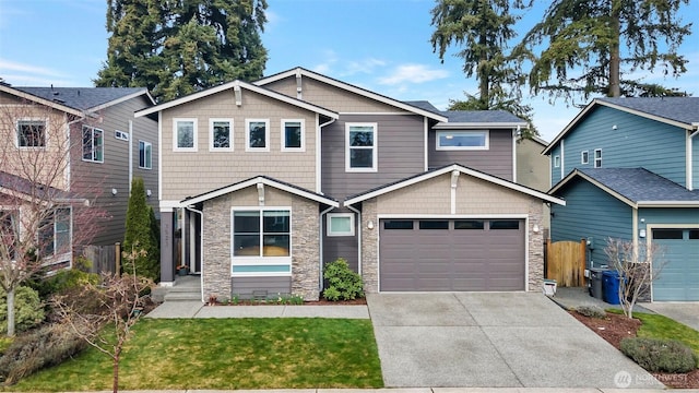 craftsman-style house featuring a garage, stone siding, and concrete driveway