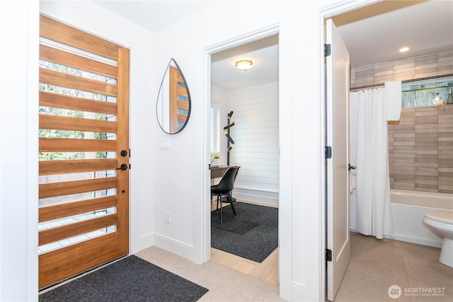 tiled foyer entrance with recessed lighting