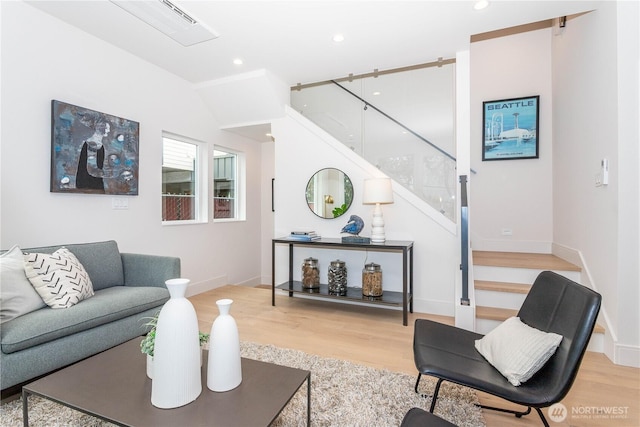 living room with stairway, recessed lighting, wood finished floors, and baseboards