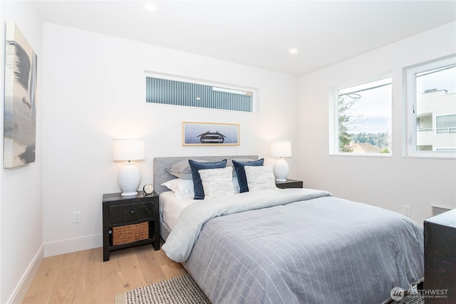 bedroom with recessed lighting, baseboards, and wood finished floors