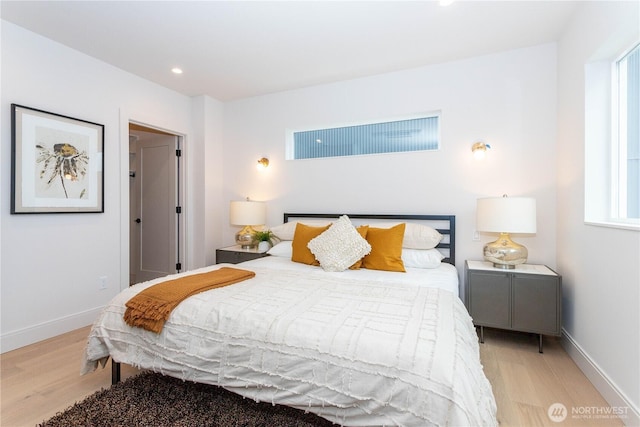 bedroom featuring light wood finished floors, recessed lighting, and baseboards