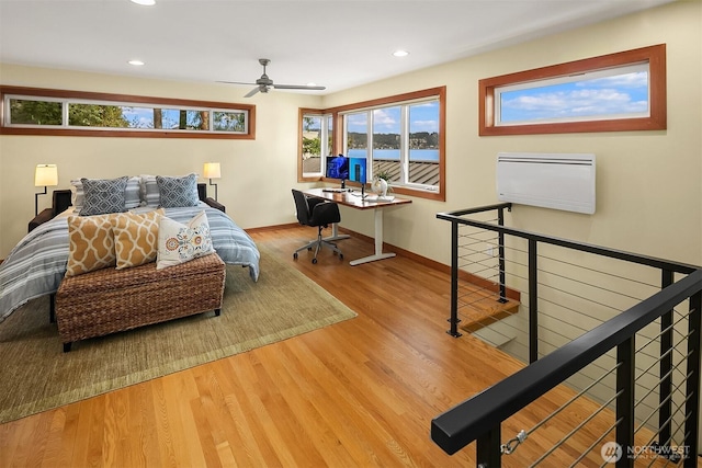 bedroom with recessed lighting, baseboards, and wood finished floors