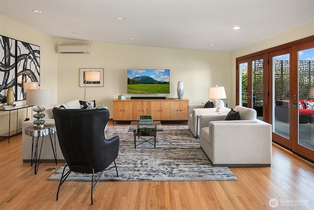 living room featuring recessed lighting, french doors, an AC wall unit, and wood finished floors