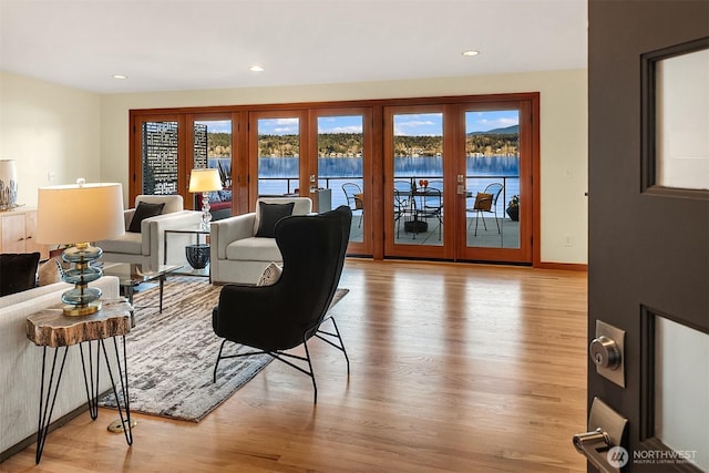 living area with wood finished floors, recessed lighting, french doors, and a wealth of natural light