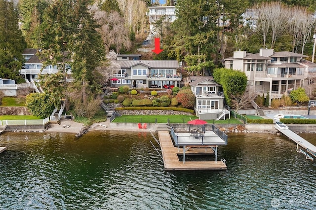 dock area featuring stairway and a water view