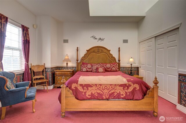 carpeted bedroom featuring a closet and visible vents