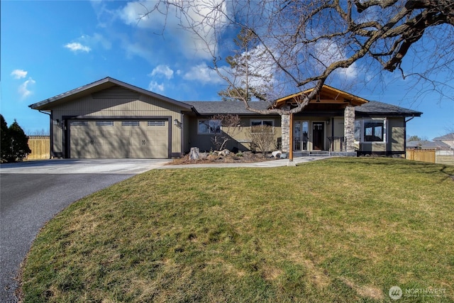 ranch-style house with driveway, a front lawn, an attached garage, and fence