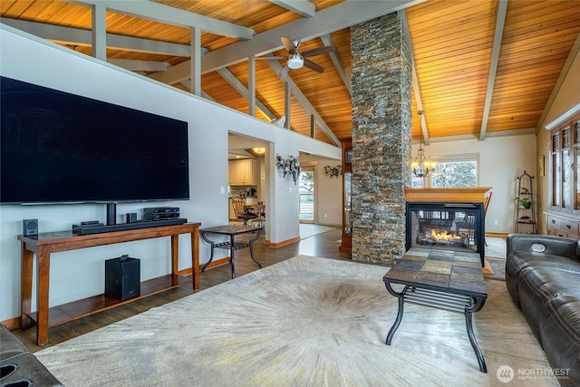 living room with wooden ceiling, a fireplace, wood finished floors, baseboards, and beamed ceiling