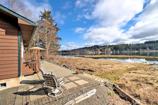 view of yard featuring a patio and a water view