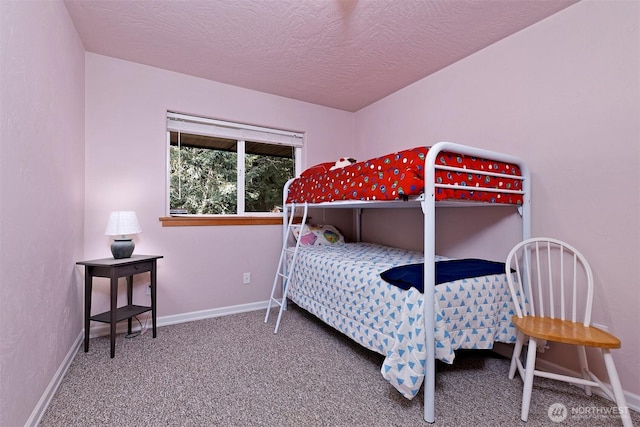 bedroom featuring baseboards, carpet, and a textured ceiling