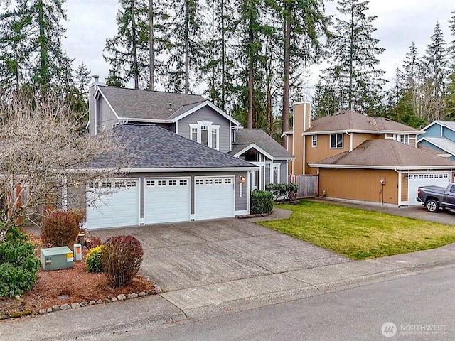 view of front of home with a shingled roof, a front lawn, a chimney, a garage, and driveway