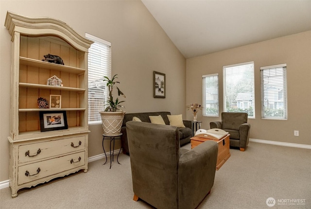 living room with light colored carpet, baseboards, lofted ceiling, and a healthy amount of sunlight